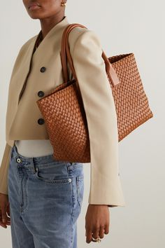 Bottega Veneta's 'Cabat' tote perfectly showcases the label's fine craftsmanship. Made from supple strips of leather using the signature intrecciato technique, this boxy and streamlined accessory has a spacious interior. Wear it with a tailored suit and statement pumps.   Group bag image is for illustrative purposes only. Shown here with 'Cabat mini' Net A Porter Bottega Veneta, Bottega Veneta Net A Porter, Bottega Veneta Classic Bag, Bottega Veneta Cabat Bag, Elegant Cognac Woven Leather Shoulder Bag, Luxury Woven Leather Bag For Work, Workwear Woven Leather Shoulder Bag, Leather Work Bag With Braided Handles, Leather Bags With Braided Handles For Work