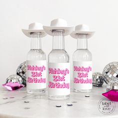 three personalized birthday water bottles sitting on a table