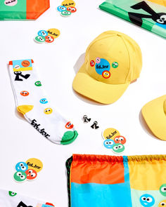 various items are laid out on a white surface including hats, socks and other accessories