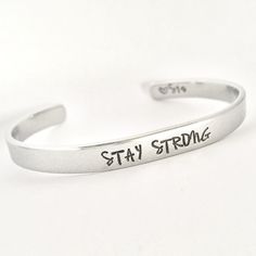 STAY STRONG This inspirational hand stamped cuff bracelet makes the perfect gift to give or treat for yourself. The cuff is 1/4 inch by 6 inches and is bent to fit most wrists. My items are hand stamped by me, making them a unique gift. Each letter is stamped individually and may not line up exactly adding to the charm and uniqueness of the gift. Visit my shop to view all of my other items by clicking here: https://www.etsy.com/shop/GemsbyJohnna Please see my shop header for current production t Inspirational Adjustable Engraved Cuff Bracelet, Inspirational Engraved Adjustable Cuff Bracelet, Adjustable Engraved Inspirational Cuff Bracelet, Adjustable Hand Stamped Name Bracelet, Personalized Inspirational Cuff Bracelet For Everyday, Everyday Inspirational Personalized Cuff Bracelet, Meaningful Hand Stamped Cuff Bangle, Adjustable Silver Name Bracelet With Hand Stamped Details, Silver Adjustable Name Bracelet, Hand Stamped