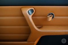 the interior of a car with leather trim and door handles, including a cup holder