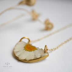 Our Luna necklace is a made from a minimal half moon shape brass frame with a half of a daisy shining down like moon light. The Daisy is a symbol of Hope. 🌼 Chain is 24k gold plated over brass. Ships in gift worthy packaging. The symbolism of the botanical is printed on a tag included with your jewelry. Matte Black Jewelry, Luna Necklace, Symbol Of Hope, Flower Resin Jewelry, Making Resin Jewellery, Captain Kirk, Moon Light, Resin Projects, Moon Shape