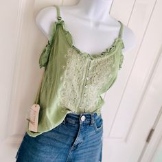 Shyanne Green Sage & Gold Sequin Strappy Lettuce Edge Embroidered Blouse Sz Xs. This Adorable Strappy Tank Top Is Just The Right Amount Of Summer And Shimmer! Features Adjustable Straps And Spare Sequins. The Embroidery Detail On This Blouse Is Beautiful! Pairs Well With Jeans And Boots/Sandals. Measures 19 1/2” Pit To Pit 23” In Length (Adjustable Straps!) Comes From A Smoke-Free, Doggo Loving Home :) Spring Cotton Camisole With Floral Embroidery, Summer Embroidered Cotton Lace Top, Spring Floral Embroidered Cotton Camisole, Embroidered Cotton Lace Top For Summer, Spring Floral Embroidery Cotton Camisole, Spring Lace Trim Camisole, Spring Cotton Lace Top With V-neck, Trendy Lace Trim Camisole For Spring, Casual Floral Embroidered Camisole For Summer