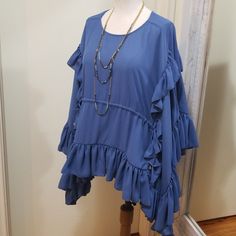 Gorgeous Blouse By Olympiah, The High-End Luxury Designer Mother-Daughter Duo From Sao Paulo, Brazil. Formed Out Of The Love Of Putting Needle To Thread, For Women Who Love Passion And Originality In Their Clothes. Size 40 Is Equal To A 6, But Would Fit A Size 8 Better. Retail Approx $254 New With Tags! Slate Blue Color (Like Actual Photos) Ruffled Sleeves Cascade Down The Sides Of The Blouse. Round Neckline, Ruched Waist, Side Ties. Measures 38" Bust, Length From Shoulder Is About 28" Flowy Blouse With Ruffle Hem And Sleeves, Flowy Ruffle Sleeve Blouse With Ruffle Hem, Summer Ruffle Sleeve Layering Blouse, Blue Flutter Sleeve Tops With Ruffle Hem, Blue Tops With Ruffle Hem And Flutter Sleeve, Elegant Blue Tops With Ruffle Hem, Flowy Blue Top With Ruffle Sleeves, Blue Flowy Top With Ruffle Sleeves, Blue Flowy Tops With Ruffle Sleeves