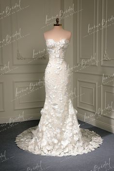 a white wedding dress with flowers on it