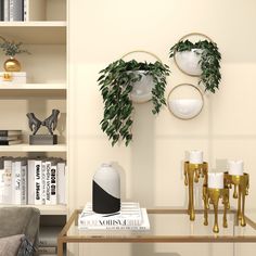 two white vases are sitting on a table in front of a book shelf with books