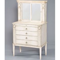 an antique white dresser with mirrored doors and drawers on the top shelf, against a gray background