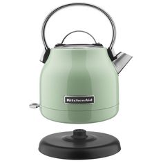 a kettle that is sitting on top of a stand with the handle extended to it