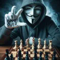 a person in a mask playing chess with the words game over written on their hand