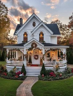 a white house with wreaths on the front porch