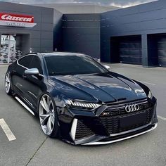 a black car parked in front of a building