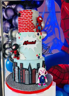 a spiderman themed birthday cake on display