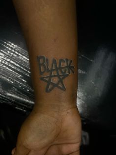 a person with a black star tattoo on their arm