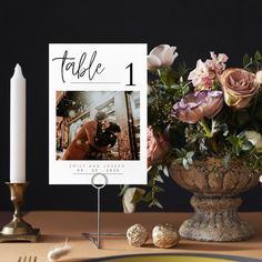 a table with flowers, candles and a card on it that says table 1 next to a candle