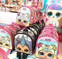 the littlest backpacks are lined up on display in front of other bags and toys