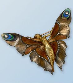 An Art Nouveau gold, enamel and diamond brooch, by Lucien Gaillard, French, 1900s. Designed as a butterfly woman with outstretched wings, partially enamelled and highlighted with rose-cut diamonds. Signed GL and numbered. 7.8 x 6.7cm. #LucienGaillard #ArtNouveau #brooch Bijoux Art Deco, Bijoux Art Nouveau, Gold Brooch, Art Nouveau Jewelry, Diamond Brooch, Butterfly Jewelry, Deco Jewelry, 판타지 아트, Art Deco Jewelry