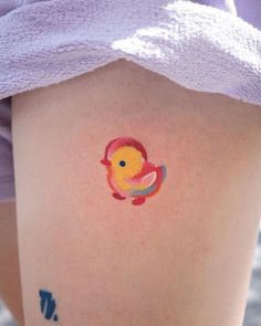 a person with a small tattoo on their thigh