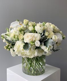 a vase filled with white flowers on top of a table