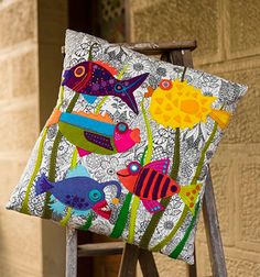 an easel is decorated with colorful fish and flowers