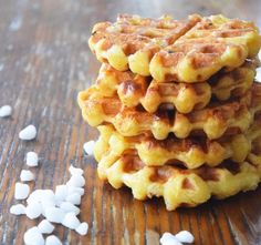 a stack of waffles sitting on top of a wooden table