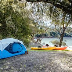 two kayaks sitting next to each other near a lake