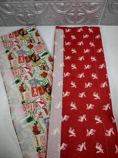 two red and white scarfs sitting next to each other on top of a counter