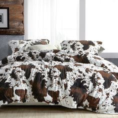 the comforter is made up with brown and white cow print on it's sheets