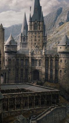 an image of a castle in the middle of the day with mountains in the background