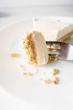 a piece of cake on a white plate with a fork in it and crumbs around the edge