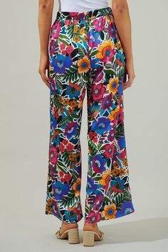 Keep your look breezy and cute on your next vacation with the Santa Elena Floral Wide Leg Pants! An elastic waistband hugs the waist, while sitting high. The pant legs open up to create the perfect wide leg fit. Style them with different textures or wear it as a set with any satin top! - Satin- High waisted- Wide leg- Flowy- Color: Floral MultiSize + Fit - Model is 5'8" and wearing size XS- Measurements taken from size S - Waist: 28 1/2" - Inseam: 29 1/4" Fabric self: 100%polyester / lining: 97% Summer Floral Print Wide-leg Pants, Multicolor Vacation Pants With Elastic Waistband, Multicolor Floral Print Beachwear Bottoms, Multicolor Floral Print Bottoms For Beachwear, Beachwear Multicolor Floral Print Bottoms, Summer Wide Leg Pants With Floral Print, Summer Wide Leg Floral Print Pants, Printed Summer Bottoms For Vacation, Summer Printed Bottoms For Vacation