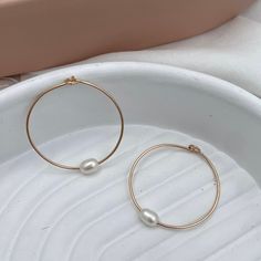 Hand-forged hoops featuring a single freshwater pearl are the perfect everyday accessory. Simple, clean, classic lines you'll never want to take off. Hand-made in our studio. These super lightweight hoop earrings are made of sterling silver or 14kt gold fill wire. Approximately 1 1/4 inch diameter.