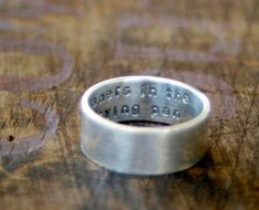 "Sterling silver personalized ring with a secret message. Custom stamped on the inside of the ring with your wedding date, nickname, quote for a private message. Each band is finished with an organic and rustic brushed surface to create a matte finish. It measures about 7mm high, which is a bit over 1/4\". A nice solid size. We can use all lowercase or all uppercase. If you don't specify we will use lowercase. Please see our policies page for the turn around time on orders here... http://etsy.me Personalized Ring, Secret Messages, Personalized Rings, Wedding Date, Ring Sterling Silver, Sterling Ring, Band Rings, Sterling Silver Rings, Rings For Men