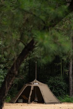 a tent pitched up in the middle of a forest