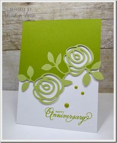 a green and white card with flowers on it