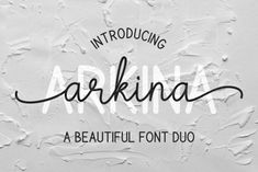 an artistic typeface with the word arkina written in black ink on a white background