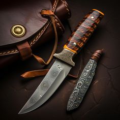 two knives sitting on top of a table next to a brown bag and leather case