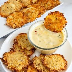 some fried food on a white plate with dipping sauce