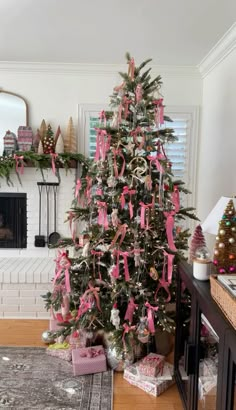 a decorated christmas tree with pink ribbons