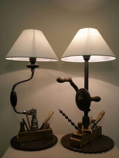 two lamps on top of a table with tools in them and one light turned on