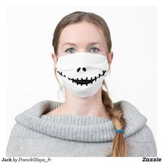 a woman wearing a white face mask with black teeth