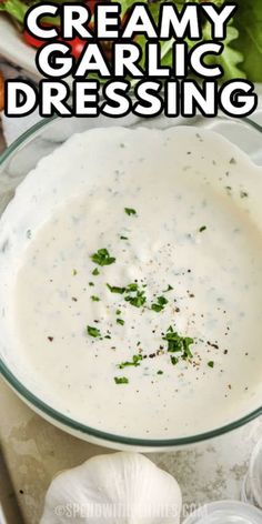 creamy garlic dressing in a glass bowl with parsley on the side and text overlay