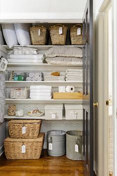 an organized pantry with baskets and toilet paper