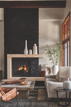 a living room filled with furniture and a fire place in the middle of the room