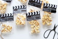 several bags of popcorn sitting next to a pair of scissors