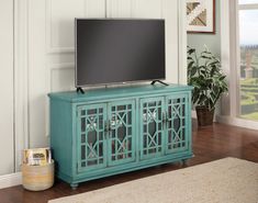 a flat screen tv sitting on top of a blue cabinet