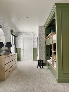 a bedroom with bunk beds and green walls in the corner, next to a dresser