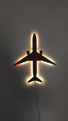 an airplane flying through the air with its lights on