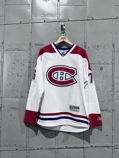 an old hockey jersey hanging on a wall