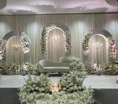 a white couch sitting on top of a table covered in flowers