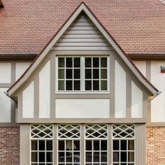 a large brick house with white trim and windows